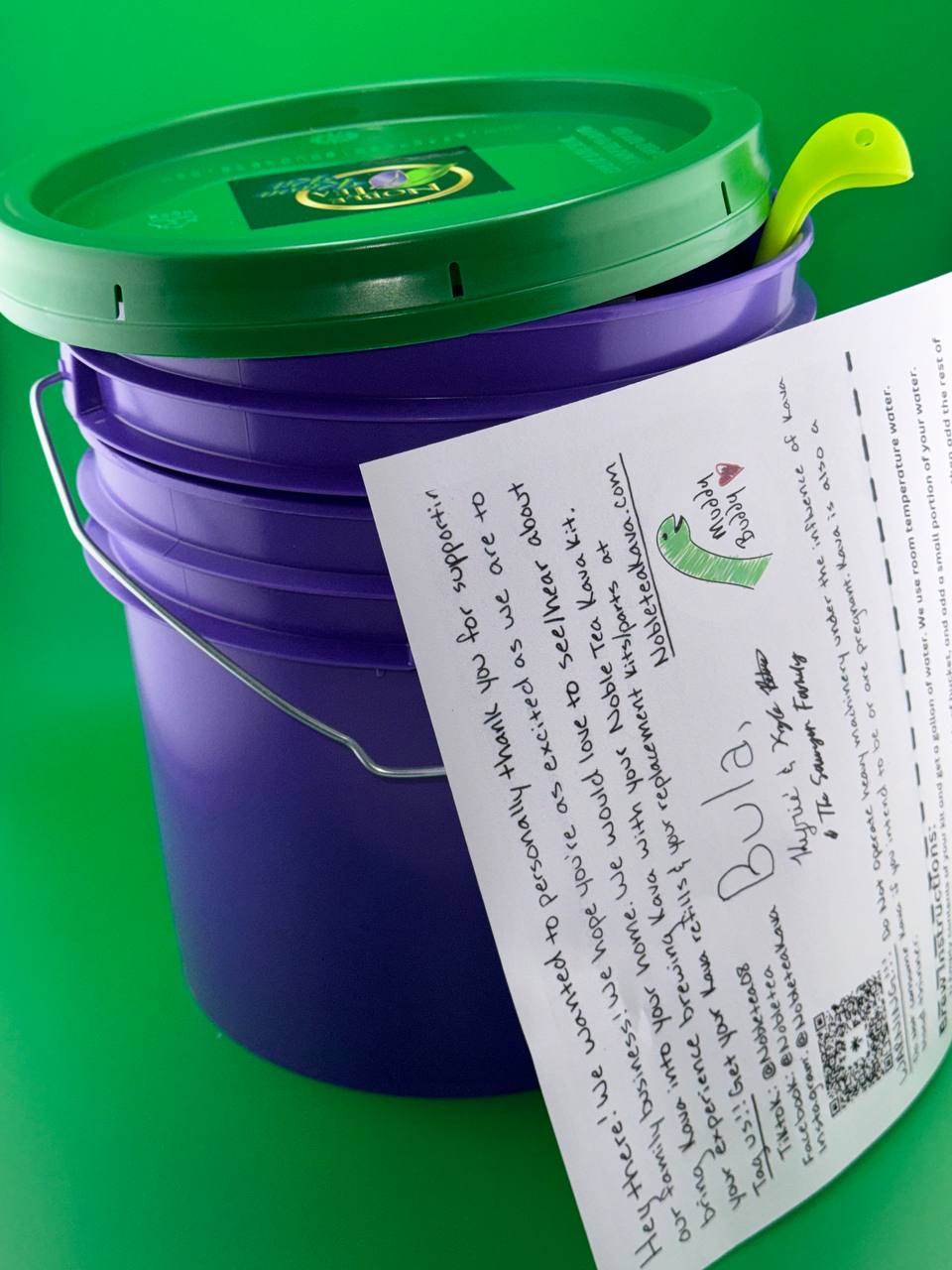 purple bucket with green lid
