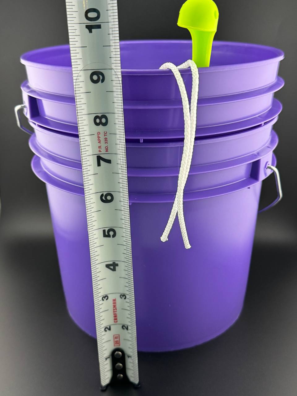 Two Noble Tea Kava purple one-gallon buckets with green ladle